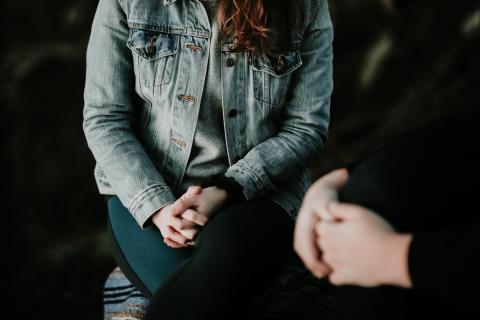 person being counselled, with just their body in the frame. 